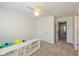 Neutral bedroom with light-colored carpet, ceiling fan, and view into the hallway and adjacent rooms at 12772 Tram Ln, Carmel, IN 46032