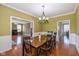 Dining room with a wooden table, chairs, and view into living room at 12772 Tram Ln, Carmel, IN 46032