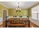 Dining room with a wooden table, bench, and chandelier at 12772 Tram Ln, Carmel, IN 46032