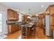 Spacious kitchen features an island with a wine rack, granite countertops, stainless appliances, and wood cabinets at 12772 Tram Ln, Carmel, IN 46032