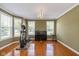 Bright and airy living room with large windows, exercise equipment, and piano at 12772 Tram Ln, Carmel, IN 46032