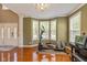 Bright and airy living room with large windows, exercise equipment, and piano at 12772 Tram Ln, Carmel, IN 46032