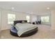 Expansive main bedroom with a round bed, carpeting, and a separate office area near the windows at 12772 Tram Ln, Carmel, IN 46032