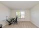 Bright, carpeted office with a modern desk, ergonomic chair, and a large window at 12772 Tram Ln, Carmel, IN 46032