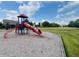 Outdoor playground featuring a slide and climbing structure on a wood chip play area at 12772 Tram Ln, Carmel, IN 46032