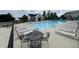 Relaxing pool area with ample lounge chairs, and a nearby building for added convenience at 12772 Tram Ln, Carmel, IN 46032