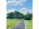 Enjoy leisurely strolls on the winding walking path through lush green lawns and mature trees at 12772 Tram Ln, Carmel, IN 46032