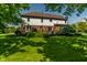 Wide backyard with lush lawn, mature trees, and charming landscaping, creating a picturesque outdoor setting at 14149 Ledgewood Way, Carmel, IN 46032
