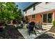 Inviting backyard patio with Adirondack chairs, fire pit, BBQ grill, and string lights perfect for entertaining at 14149 Ledgewood Way, Carmel, IN 46032