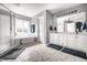 Bright bathroom with dual sinks, white cabinets, and a separate shower and soaking tub at 14149 Ledgewood Way, Carmel, IN 46032
