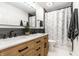 Modern bathroom with double vanity, stylish fixtures, and tiled shower with glass doors at 14149 Ledgewood Way, Carmel, IN 46032