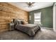 Spacious bedroom featuring wood accent wall, large bed, and neutral color palette at 14149 Ledgewood Way, Carmel, IN 46032