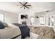 Primary bedroom featuring light walls, wood floors, and a cozy fireplace at 14149 Ledgewood Way, Carmel, IN 46032