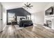 Primary bedroom with wood accent wall, fireplace, and light wood flooring at 14149 Ledgewood Way, Carmel, IN 46032