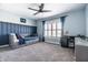 Bright bedroom with custom wood paneling, ceiling fan, and window with privacy shutters at 14149 Ledgewood Way, Carmel, IN 46032