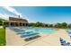 Community pool featuring lounge chairs and a clubhouse, perfect for relaxation and recreation at 14149 Ledgewood Way, Carmel, IN 46032