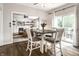 Cozy dining area with table and four chairs is located next to an open living room and a sliding glass door at 14149 Ledgewood Way, Carmel, IN 46032