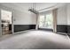 Well lit dining room with two-tone walls and a chandelier that opens into a room with a shuttered window at 14149 Ledgewood Way, Carmel, IN 46032