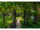 Beautiful garden entrance featuring a stone pathway and iron gate at 14149 Ledgewood Way, Carmel, IN 46032