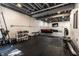 Home gym featuring black gym mat, painted block walls, weight racks, and workout equipment at 14149 Ledgewood Way, Carmel, IN 46032