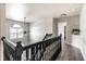 Bright hallway with dark wood trim, hardwood floors, and natural light coming through the window at 14149 Ledgewood Way, Carmel, IN 46032