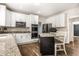 Modern kitchen featuring white cabinets, granite countertops, and stainless steel appliances at 14149 Ledgewood Way, Carmel, IN 46032