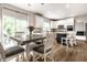 Bright kitchen area with white cabinets, granite countertops, stainless appliances, and an eat-in table at 14149 Ledgewood Way, Carmel, IN 46032