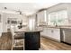 Well-appointed kitchen featuring white cabinets, granite counters, and an island with seating at 14149 Ledgewood Way, Carmel, IN 46032