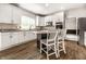 Bright kitchen with granite countertops, white cabinetry, and stainless steel appliances offers a modern design at 14149 Ledgewood Way, Carmel, IN 46032