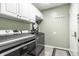 Well-lit laundry room featuring new, efficient washer and dryer set at 14149 Ledgewood Way, Carmel, IN 46032