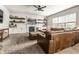 Comfortable living room with a sectional sofa, fireplace, built-in shelving, and large windows at 14149 Ledgewood Way, Carmel, IN 46032
