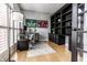 Stylish home office with custom built-in shelves, hardwood floors, and large windows at 14149 Ledgewood Way, Carmel, IN 46032