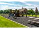 Community playground with modern play structures, seating, and a safe, cushioned ground cover at 14149 Ledgewood Way, Carmel, IN 46032