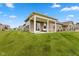 Expansive backyard view showcasing the covered patio and well-manicured lawn at 14848 Stonneger St, Westfield, IN 46074