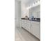 Bright bathroom featuring a double vanity with tiled floors, undermount sinks and chrome fixtures at 14848 Stonneger St, Westfield, IN 46074