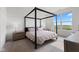 Spacious bedroom with a canopy bed frame and natural light from the large window at 14848 Stonneger St, Westfield, IN 46074