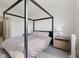 Well-lit bedroom featuring a canopy bed frame, light carpet and natural light from the window at 14848 Stonneger St, Westfield, IN 46074