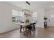 Dining room features modern chandelier, wood floors, with bright, natural light, and white walls at 14848 Stonneger St, Westfield, IN 46074