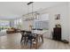 Dining room featuring modern chandelier, wood table and floors, with bright, natural light at 14848 Stonneger St, Westfield, IN 46074