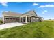 Angle view of an attractive home with an attached garage, well maintained lawn, and blue sky at 14848 Stonneger St, Westfield, IN 46074