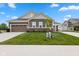 Charming home with a two-car garage, lovely landscaping, brick accents, and well-kept lawn at 14848 Stonneger St, Westfield, IN 46074