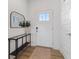 Inviting foyer with a black console table, decorative mirror, and a light-filled entryway at 14848 Stonneger St, Westfield, IN 46074
