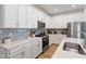 Modern kitchen with white cabinets, quartz countertops, stainless steel appliances and gray subway tile backsplash at 14848 Stonneger St, Westfield, IN 46074