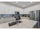Well-lit kitchen with white cabinets, stainless steel appliances and quartz countertops, great for entertaining at 14848 Stonneger St, Westfield, IN 46074