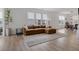 Cozy living room featuring hardwood floors, natural light, and a comfortable leather couch at 14848 Stonneger St, Westfield, IN 46074