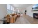 Bright and open living room with wood floors, a fireplace, and large windows for natural light at 14848 Stonneger St, Westfield, IN 46074