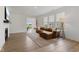 Comfortable living room with ample natural light, a fireplace, wood floors and a brown leather sofa at 14848 Stonneger St, Westfield, IN 46074