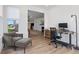 Cozy office featuring hardwood floors, natural light, and a comfortable grey chair and ottoman at 14848 Stonneger St, Westfield, IN 46074