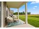 Relaxing covered patio with stylish seating, offering scenic views of lush green space at 14848 Stonneger St, Westfield, IN 46074