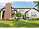 Lush backyard featuring manicured landscaping and the home's exterior brick fireplace at 1521 Avondale Dr, Westfield, IN 46074